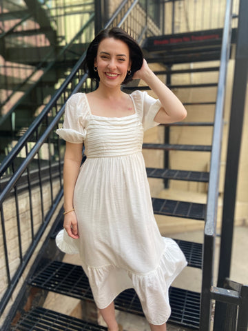 Elevate your style with the Calista White Pleated Midi Dress. This empire waist dress features a flattering pleated design and puff sleeves for a timeless look. Perfect for any occasion, this midi dress will add a touch of sophistication to your wardrobe.



Empire waist design for a flattering silhouette

Elegant pleated fabric adds timeless charm

Puff sleeves offer a soft, feminine touch

Midi length perfect for versatile occasions