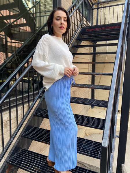 pleated blue pants with drawstring waistband detailing long raw hem light blue lightweight pants side view