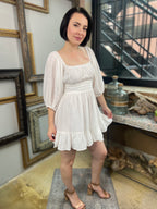 Expertly crafted in a versatile white hue, the Eve White Open Back Mini Dress features a trendy off-shoulder design with a flirty open back and a charming tie closure. Its ruffle-trimmed hem and three-quarter length sleeves create an effortlessly chic look, while the slip lining ensures a comfortable fit. Perfect for any occasion, this dress offers both style and comfort.



Off-shoulder open-back dress

Elegant and stylish design

Made with soft, breathable fabric
