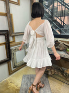 Expertly crafted in a versatile white hue, the Eve White Open Back Mini Dress features a trendy off-shoulder design with a flirty open back and a charming tie closure. Its ruffle-trimmed hem and three-quarter length sleeves create an effortlessly chic look, while the slip lining ensures a comfortable fit. Perfect for any occasion, this dress offers both style and comfort.



Off-shoulder open-back dress

Elegant and stylish design

Made with soft, breathable fabric