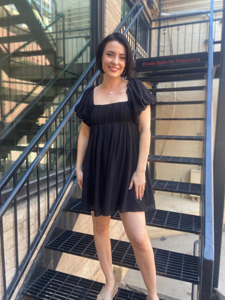 Expertly crafted, the Felix Black Ruched Mini Dress offers both style and comfort. Made from a blend of 75% rayon and 25% nylon, this solid dress features a square neckline, ruffled short sleeves, and a back cinch tie for added detail. The elastic back and two side pockets ensure a comfortable and functional fit.



Classic Square Neckline – Flattering and modern design
Short Ruffled Sleeves – Feminine and stylish detail
Back Cinch Tie Detail – Adjustable for a perfect fit
Elastic Back Panel – Provides extr
