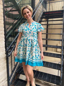 Crafted with a linen blend fabric, the Frey Turquoise Floral Dress boasts a vibrant turquoise and cream floral and stripe print. The flattering V-neck and waist-pleating create a feminine silhouette, while the flutter sleeves add a touch of whimsy. Perfect for a&nbsp;sunny occasion, this dress is a must-have for the stylish woman.