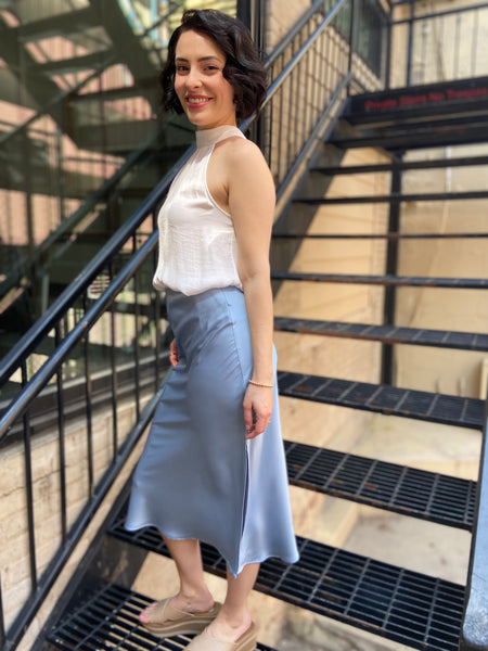 Elevate your wardrobe with the Kallie Light Blue Satin Skirt. This stunning piece features a soft satin finish that drapes beautifully, making it perfect for any occasion—be it a casual outing or an evening gala. Its light blue hue adds a touch of elegance and versatility, allowing you to pair it effortlessly with various tops and accessories.

- Luxurious satin fabric for a smooth feel
- Flattering silhouette that enhances your figure
- Easy to style for both day and night looks
- Ideal for layering or wea