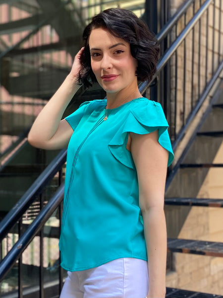 Introducing the Kezia Light Teal Ruffle Sleeve Blouse, your new go-to for effortless elegance. This blouse effortlessly combines classic style with a modern twist, featuring:

- Delicate lace trim for a feminine flair
- Flattering tulip sleeves that add grace to any outfit
- Chic pintuck detailing on the front for a refined look
- Keyhole button closure at the back that enhances its charm