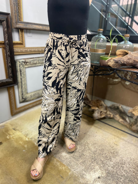 tropical tan and black pants leaf pattern drawstring pants vacation ear paired with black tank top