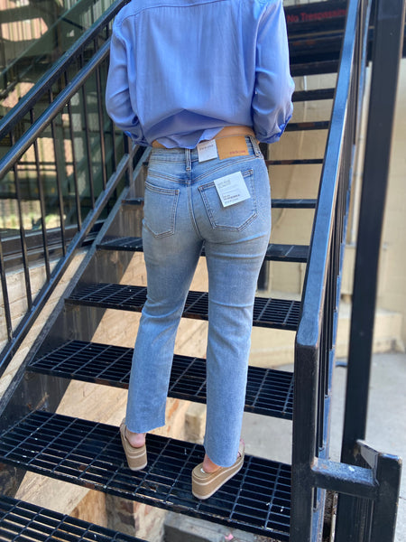 lenox straight leg light wash jeans mid rise raw hem jeans paired with light blue button up