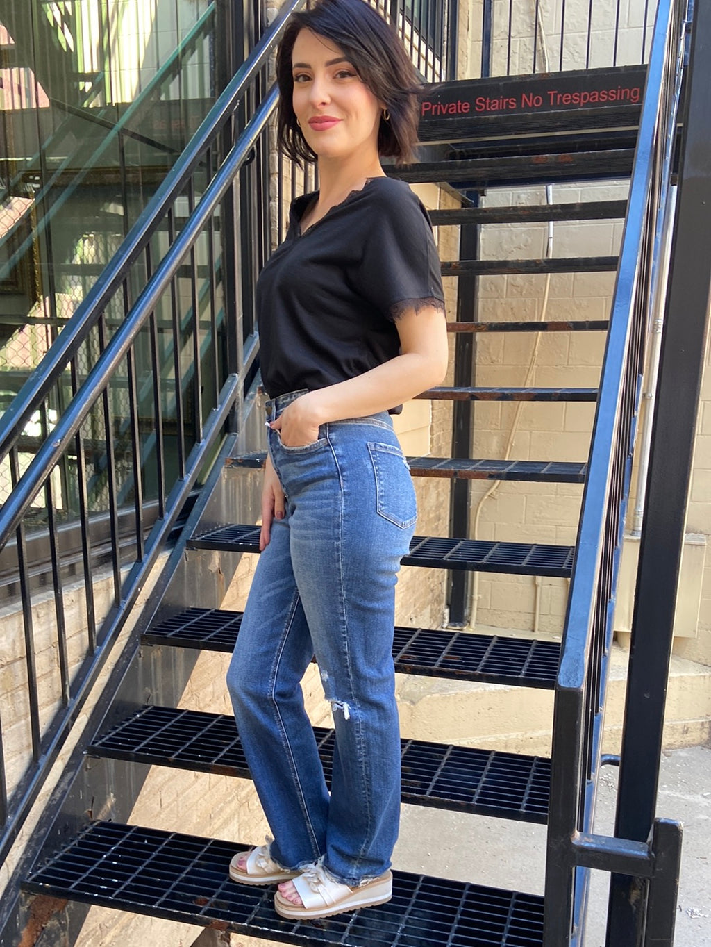 flying monkey jeans stright leg paired with black t shirt blouse knee rip on left side of jeans side view