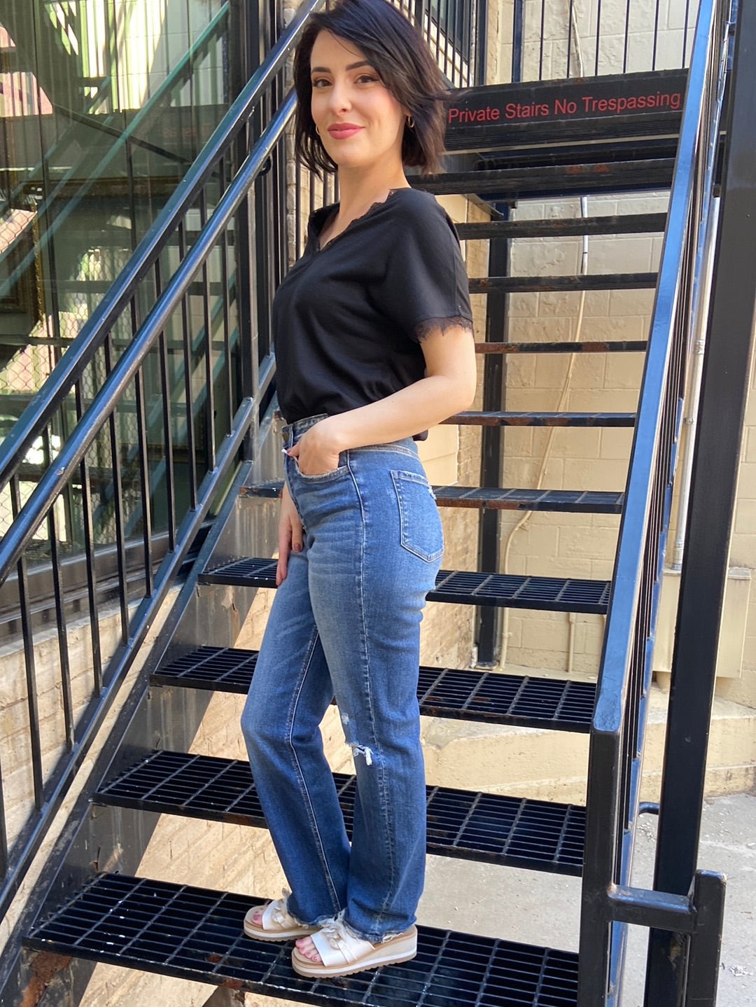 flying monkey jeans stright leg paired with black t shirt blouse knee rip on left side of jeans side view