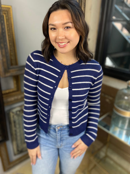 white and navy striped button down cardigan crew neck knit paired with white tank top and jeans pose view