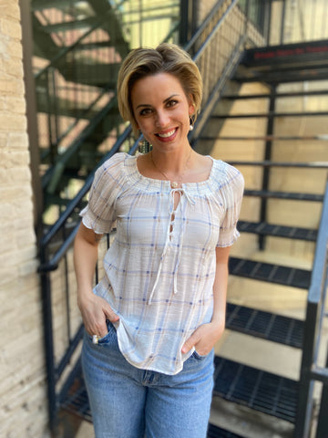 Elevate your style game with the Neville White Plaid Pattern Blouse. Its charming plaid design, complete with a playful split tie neck, offers the perfect blend of comfort and flair. Whether you're off to brunch or a casual day out, this lightweight smocked blouse ensures you look fabulous all day long.

- Classic plaid pattern for a timeless vibe
- Fun split tie neck for added style
- Lightweight smocked fabric for all-day comfort
- Pairs effortlessly with any outfit
- Composition: 63% rayon, 37% polyester