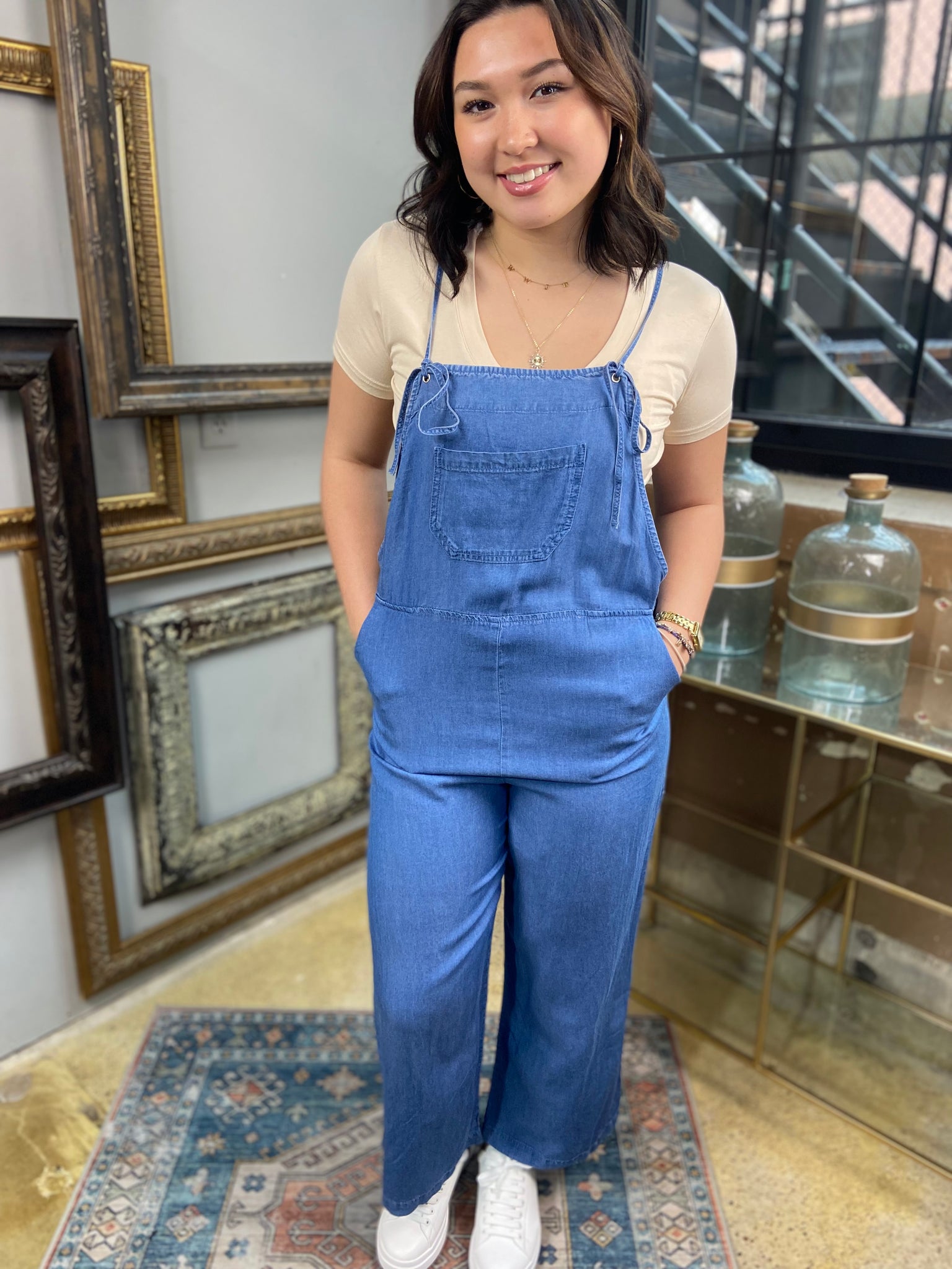 light blue denim overalls jumpsuit pockets long wide leg spaghetti straps 