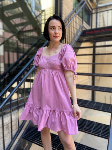 Expertly crafted for comfort and style, the Seraphine Mauve Babydoll Dress features a solid tiered design with a flattering baby doll silhouette. Cut short with puff sleeves, a scoop neck, and a ruffled hem, this mini dress offers a modern and feminine look that is perfect for any occasion.

Solid Short Sleeve Mini Dress – Classic and versatile for any occasion
Flattering Square Neckline – Enhances the neckline with a modern touch
Ruffled Short Sleeves – Adds a feminine and stylish flair
Back Cinch Tie Deta