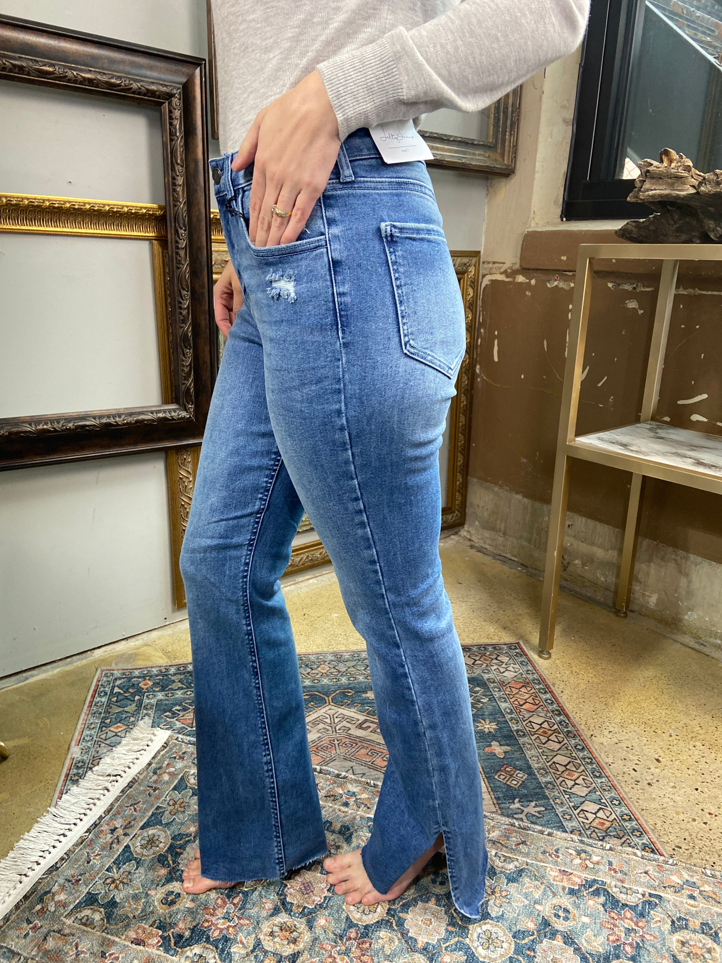 jelly jeans flare dark to medium wash side slit raw hem solid high waisted mid rise jeans paired with gray long sleeve