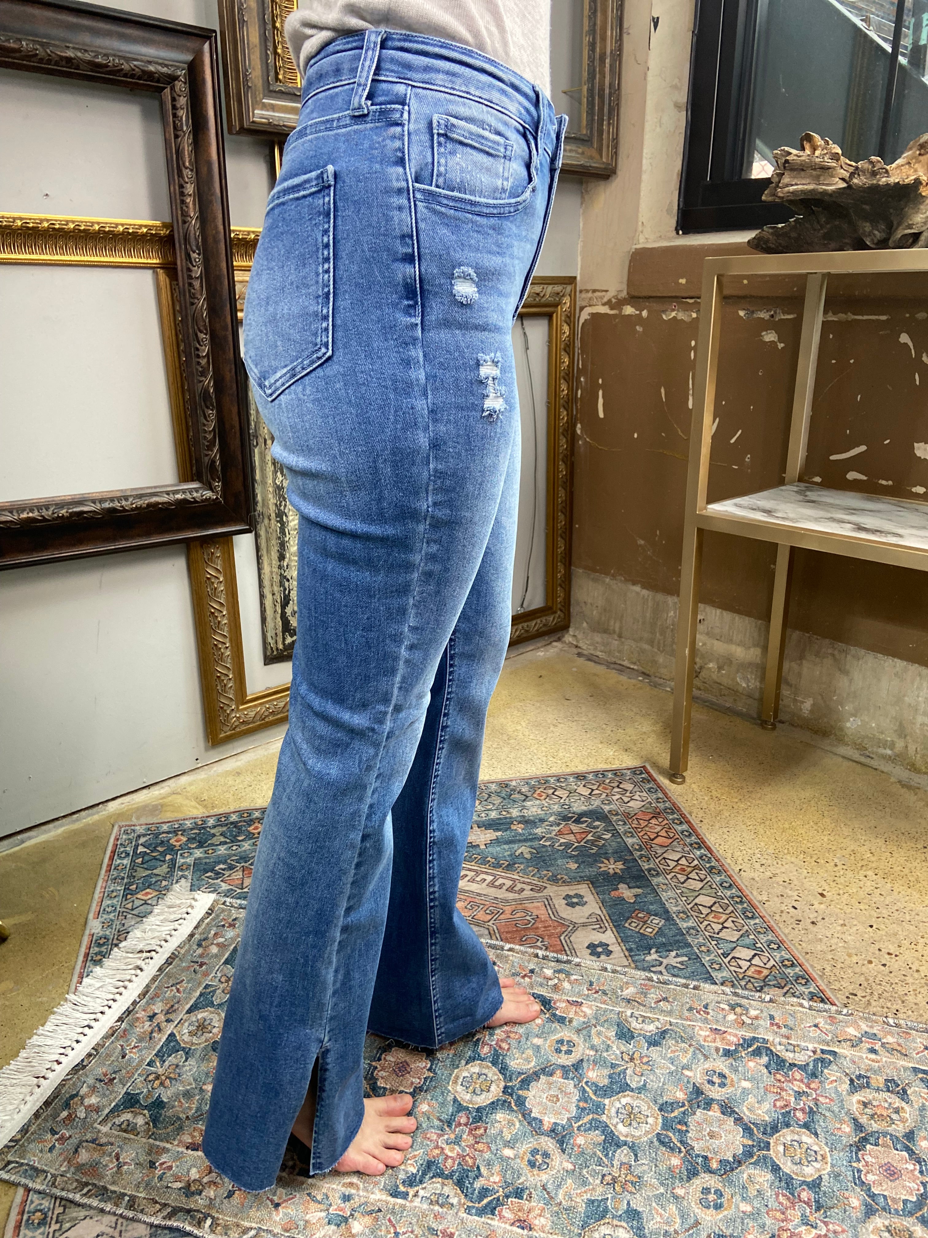 jelly jeans flare dark to medium wash side slit raw hem solid high waisted mid rise jeans paired with gray long sleeve