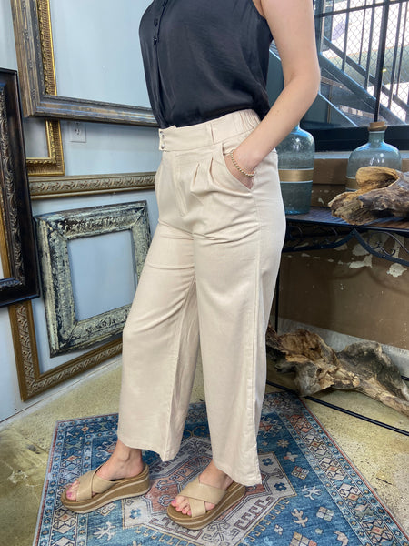 sylvie khaki linen pants with pockets double button linen pants paired with black blouse shirt