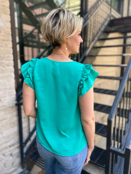 Introducing the Zelda Emerald Front Button Blouse – your new wardrobe staple that effortlessly combines style and comfort. With its beautiful emerald hue and chic front button design, this blouse is perfect for both casual outings and office wear. Pair it with your favourite jeans or tailored trousers for a polished look.

- Elegant emerald colour
- Stylish front button detail
- Versatile for any occasion
- High-quality fabric for all-day comfort
 