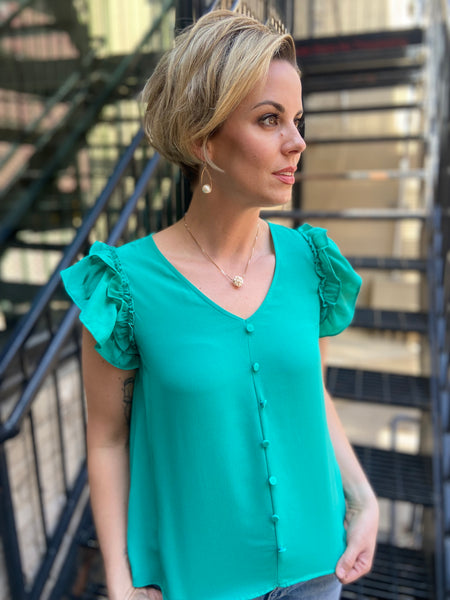 Introducing the Zelda Emerald Front Button Blouse – your new wardrobe staple that effortlessly combines style and comfort. With its beautiful emerald hue and chic front button design, this blouse is perfect for both casual outings and office wear. Pair it with your favourite jeans or tailored trousers for a polished look.

- Elegant emerald colour
- Stylish front button detail
- Versatile for any occasion
- High-quality fabric for all-day comfort
 