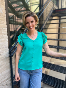 Introducing the Zelda Emerald Front Button Blouse – your new wardrobe staple that effortlessly combines style and comfort. With its beautiful emerald hue and chic front button design, this blouse is perfect for both casual outings and office wear. Pair it with your favourite jeans or tailored trousers for a polished look.

- Elegant emerald colour
- Stylish front button detail
- Versatile for any occasion
- High-quality fabric for all-day comfort
 